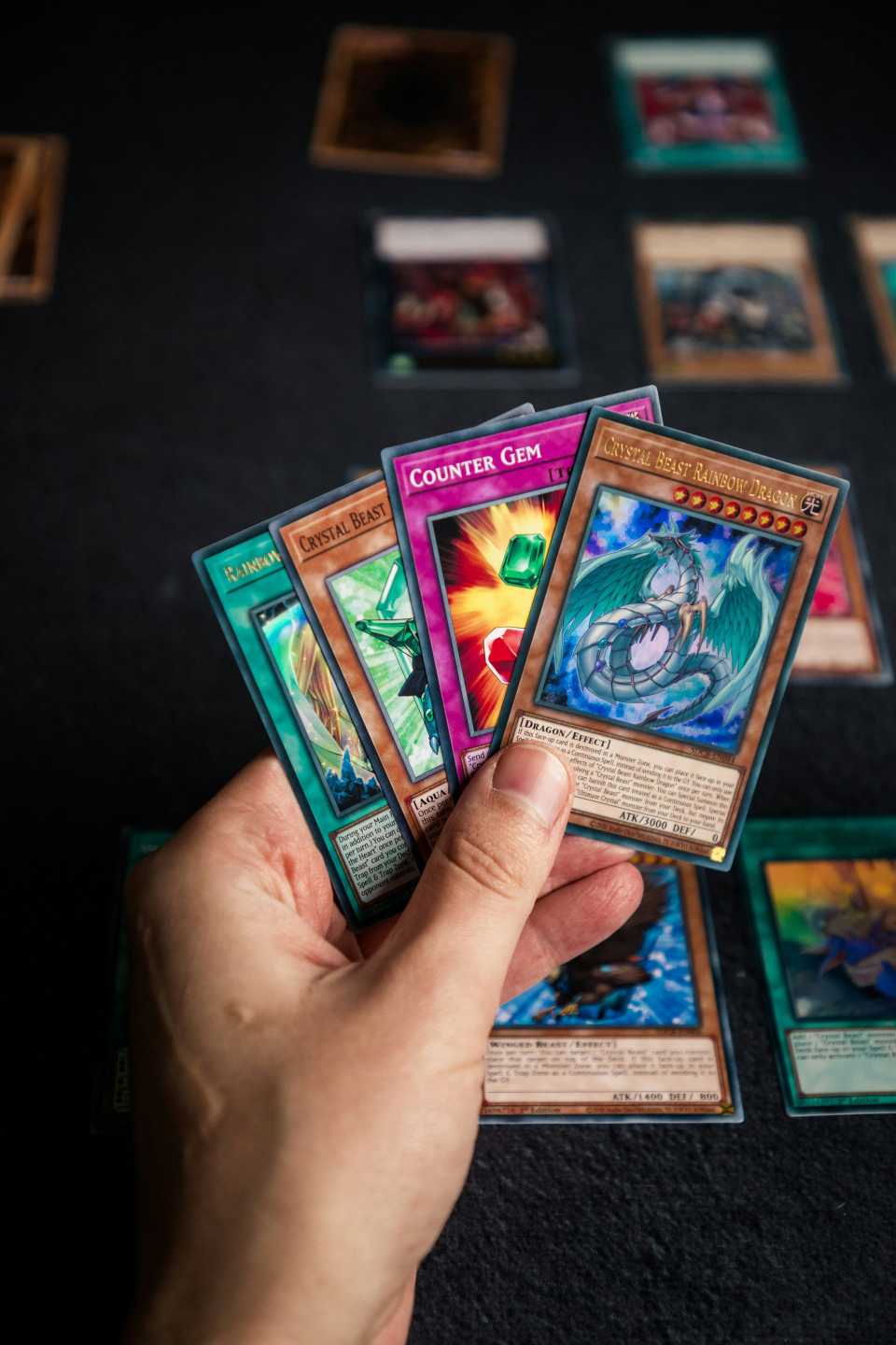 Hand holding various trading cards