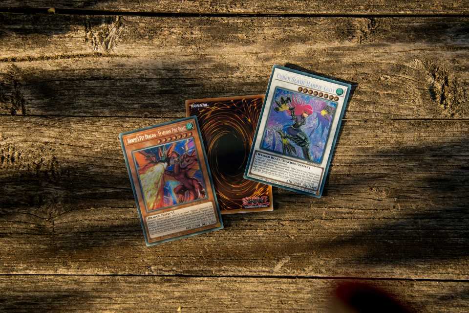 Yu-Gi-Oh! cards displayed on wooden surface.